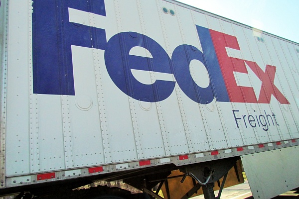 a FedEx truck passes us